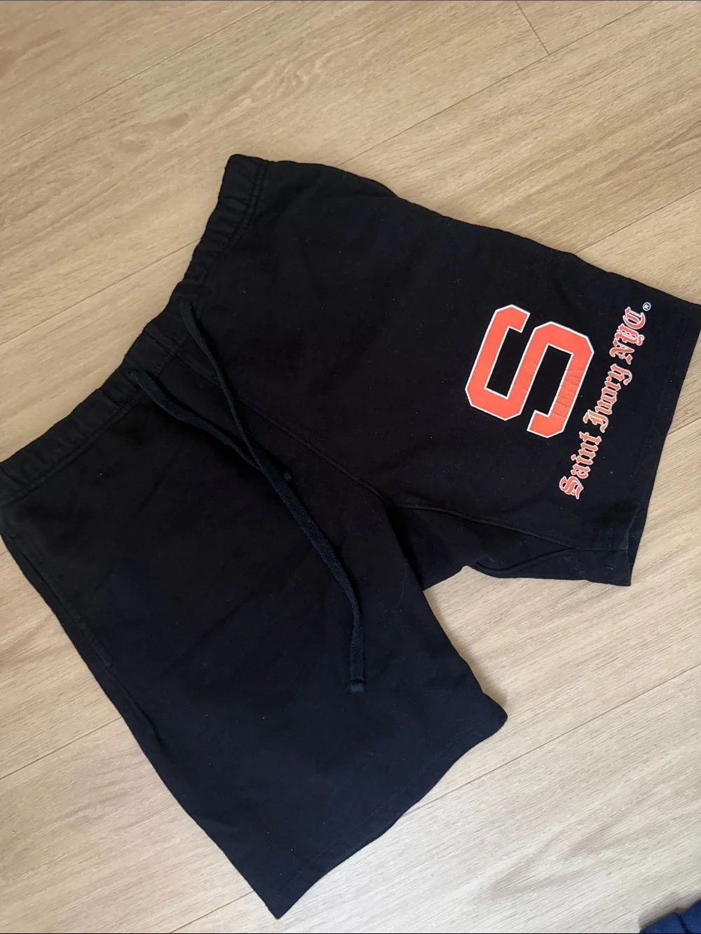 Black Athletic Shorts with Red 'S' Graphic